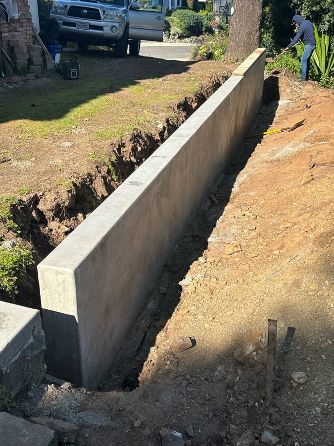 picture of foundation being put into an excavated backyard