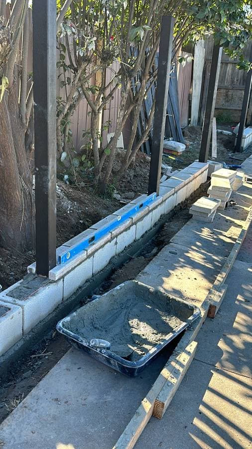 fence getting ready to be installed in a a backyard